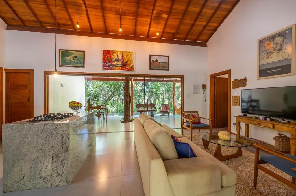 a large living room with a couch and a fireplace at Casa alto padrão próximo a praia, suíte, jacuzzi in Marau