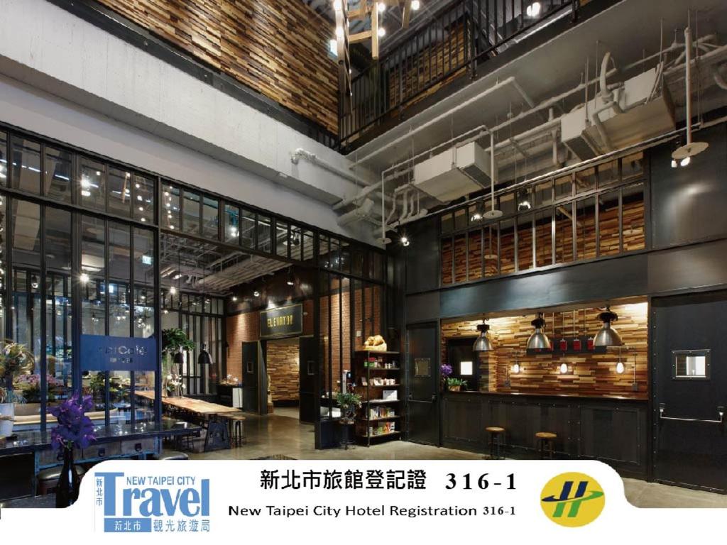 a large building with a lobby with a store at Just Sleep - Sanchong in Taipei