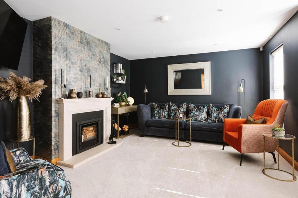 LambegにあるTobela House, Sleeps 10, Ultra Luxuryのソファと暖炉のあるリビングルーム