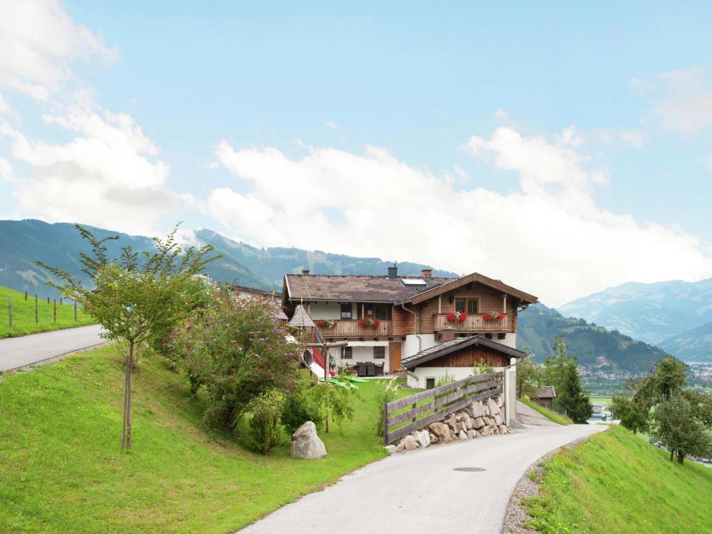 a house on a hill next to a road at Apartment Wiesbachhorn Zell am See-Kaprun in Kitzsteinhorn
