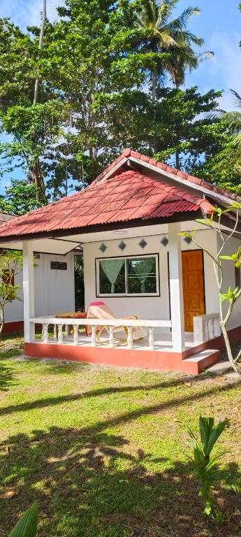 a small house with a red roof at Kohmook cocobeach in Ko Mook