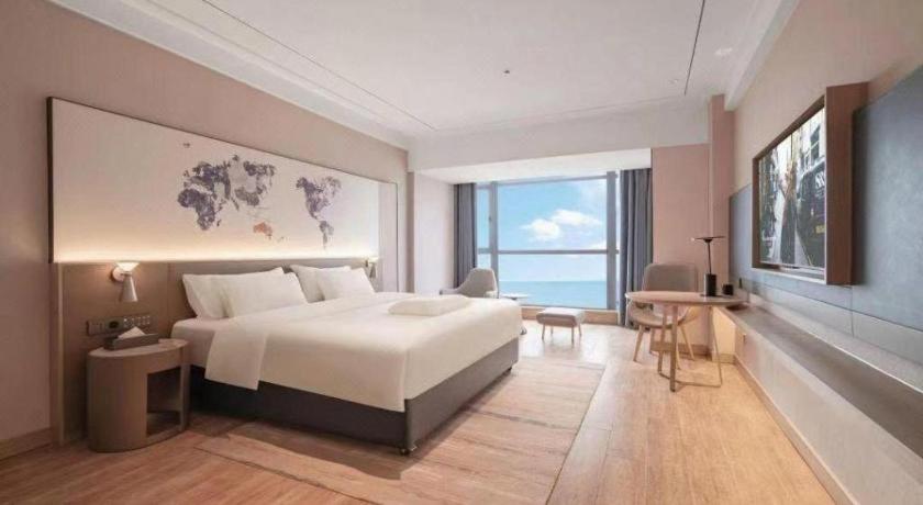 Ένα ή περισσότερα κρεβάτια σε δωμάτιο στο Kyriad Marvelous Hotel Xiangyin Bus Station