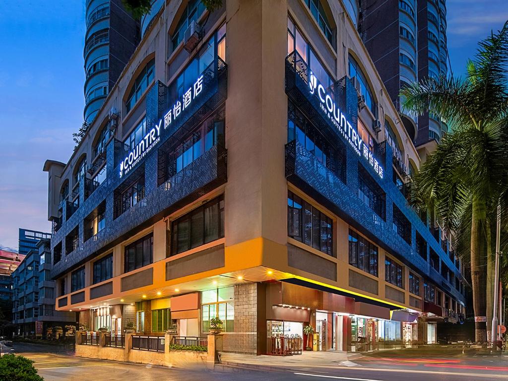 a building with a sign on the side of it at The Liyi Hotel Guangzhou Taikoo Hui Huashi Metro Station Branch in Guangzhou
