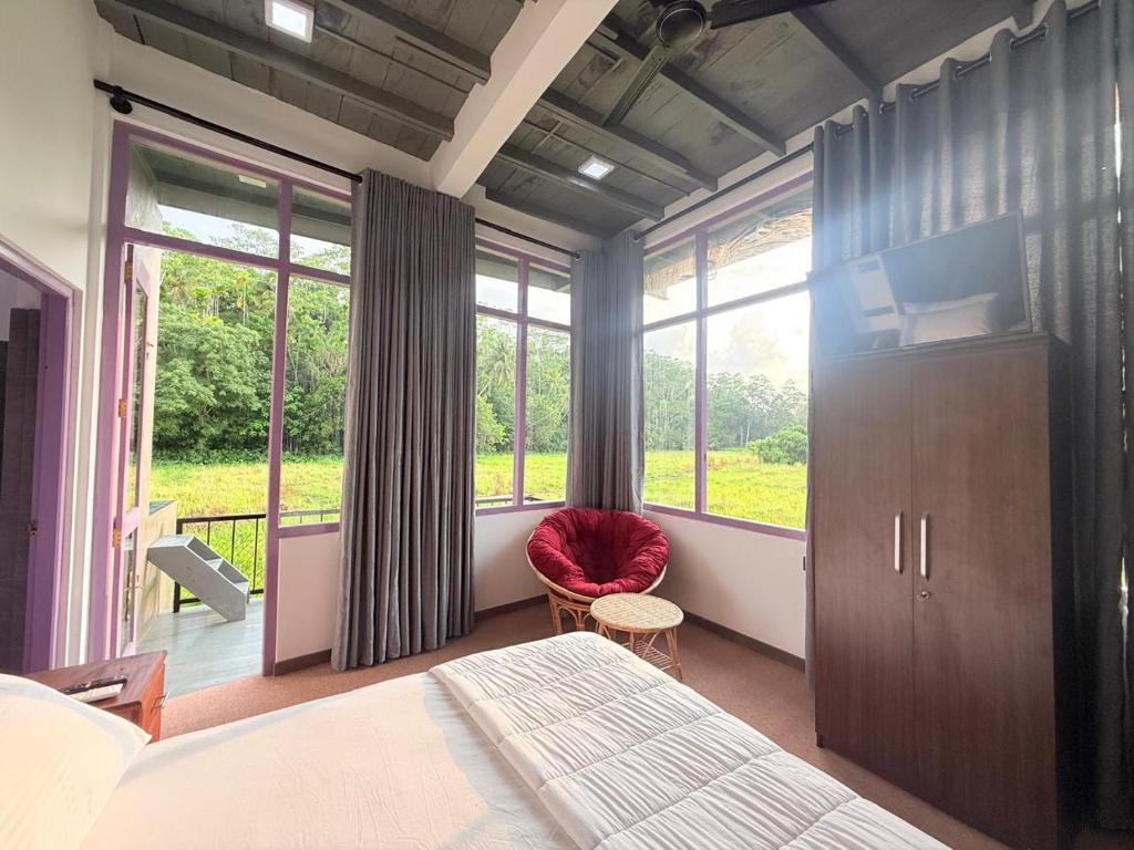 a bedroom with a bed and a large window at Calm Side Villa Hikkaduwa in Hikkaduwa