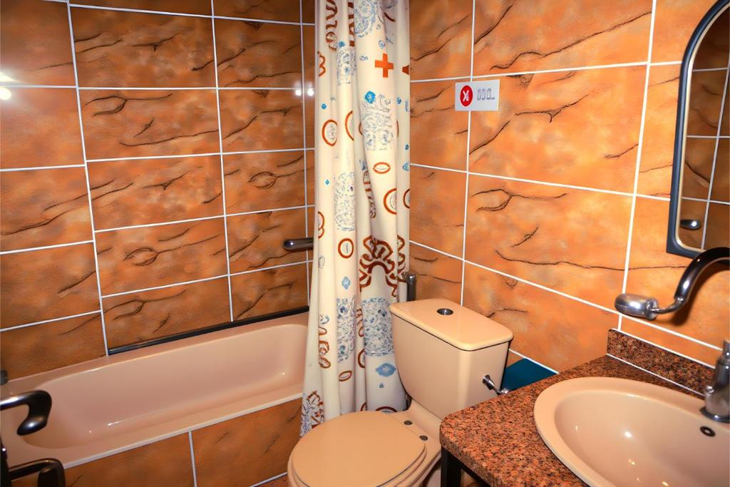 a bathroom with a toilet and a sink at Pyramids & SphinX Grand Hotel in Cairo