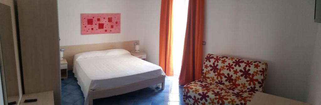 a small room with a bed and a chair at Belvedere in Procida