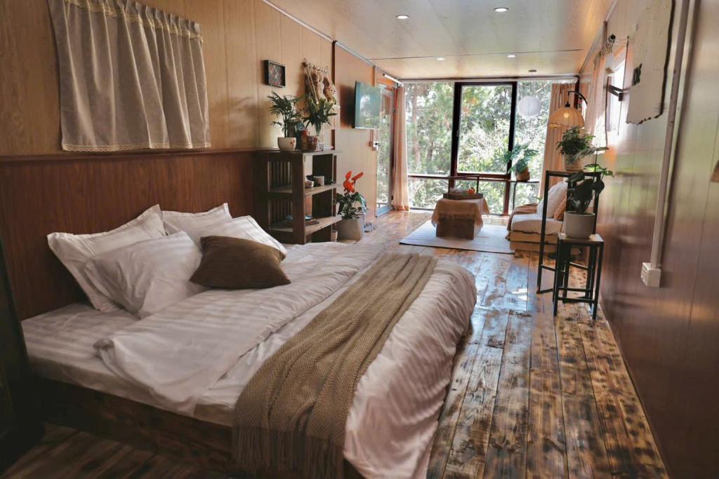 a bedroom with a large bed in a room at Xing Retreat & Spa Măng Đen in Kon Plong