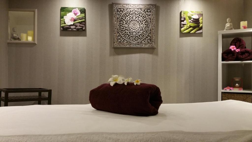 a bed with two stuffed animals on top of it at Le Trophée Boutique Hôtel Spa- La Loggia Appart'hôtel in Deauville