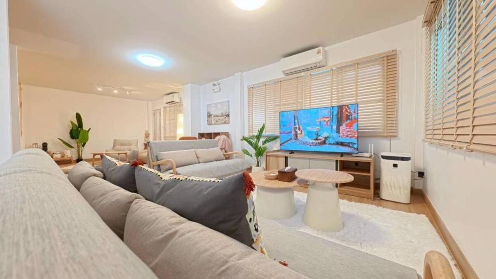 a living room with a couch and a tv at Center of old town - 3BR 3BA - Nara Lanna Villa in Chiang Mai