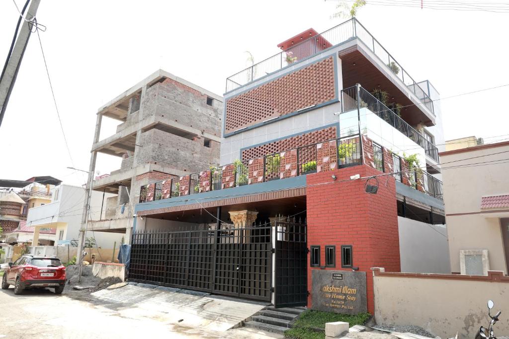a building with a balcony on top of it at VLuv Home Stay in Chennai
