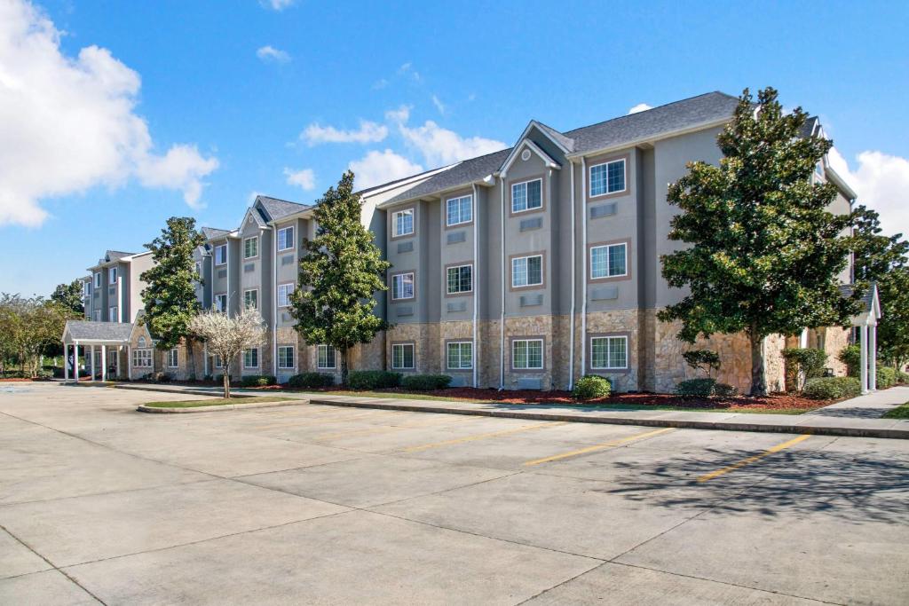 a large apartment building with a parking lot at Microtel Inn & Suites by Wyndham Pearl River/Slidell in Pearl River