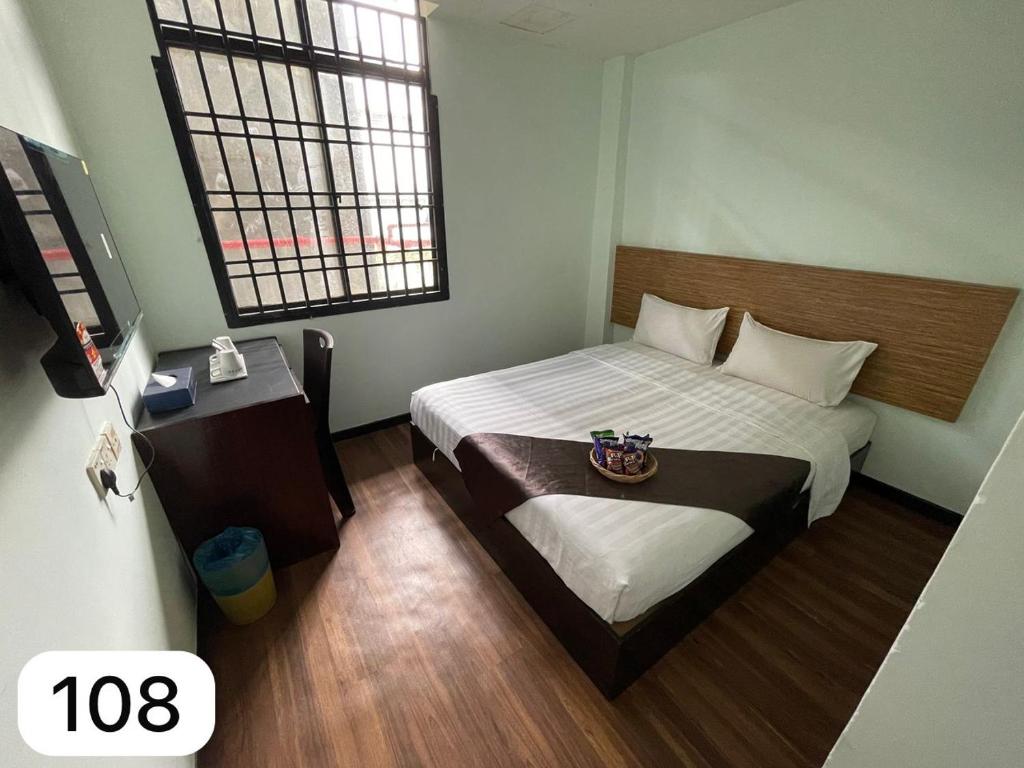 a small bedroom with a bed and a window at Ezzyhome Taman Molek in Johor Bahru