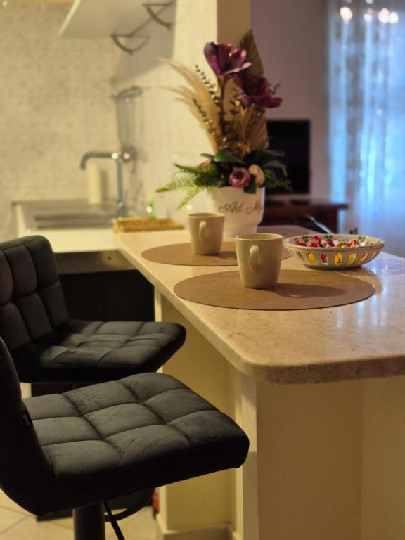 a kitchen with a counter with two cups on it at Elegantia Domina apartment in the center in Fiumicino