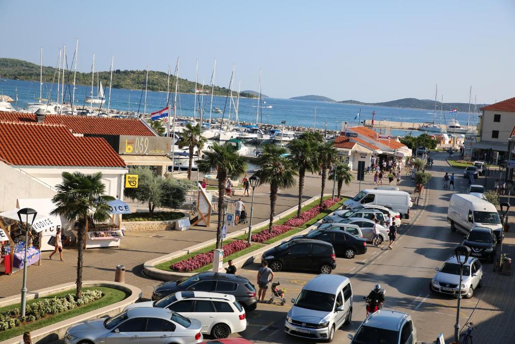 a city street with cars parked in a parking lot at Apartments Centar in Vodice