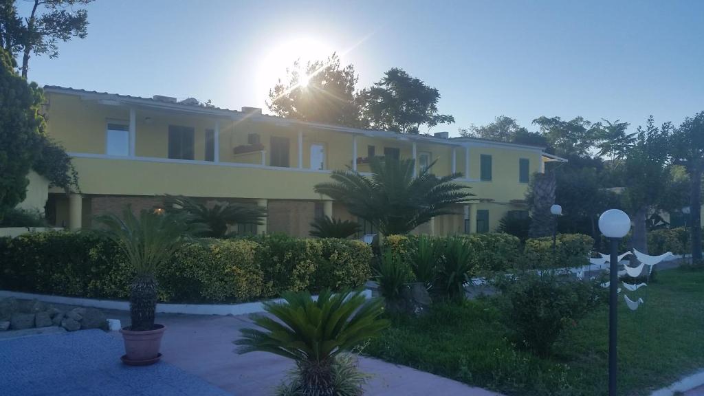 a large house with the sun shining behind it at Belvedere in Procida