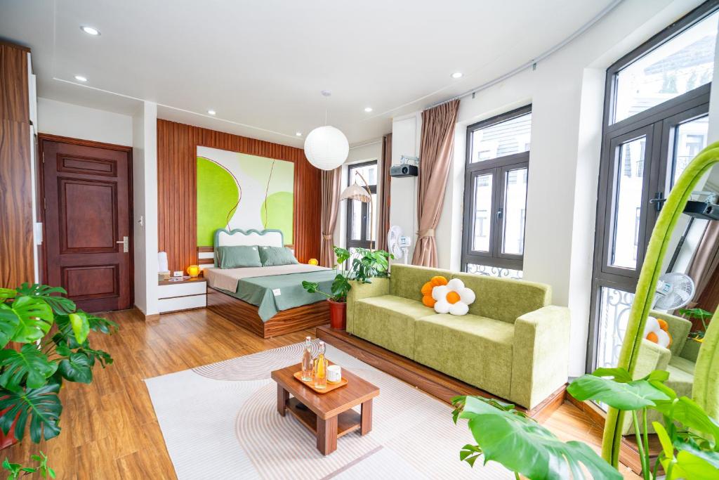 a living room with a couch and a bed at Katka Riverside Homestay Hai Phong in An Dương