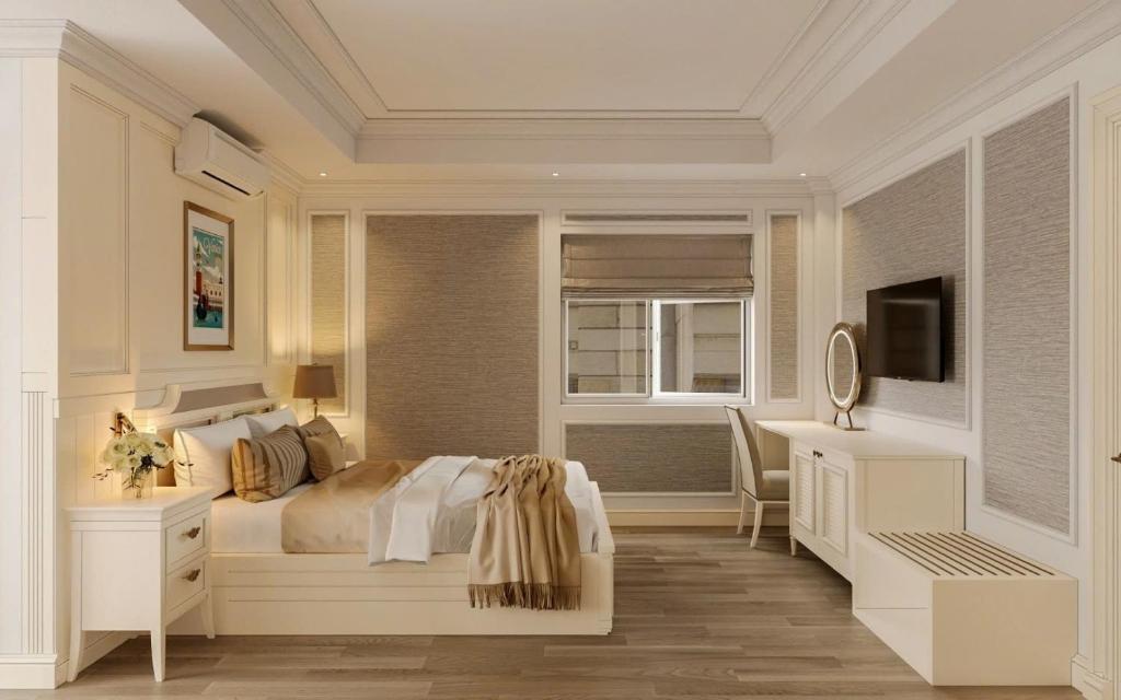 a bedroom with a bed and a desk and a television at Hoa Hong Hotel - Xa Dan in Hanoi