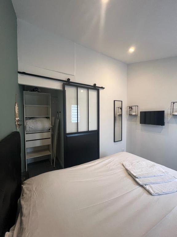 a bedroom with a bed and a closet at gîte Lemarocha in Groffliers