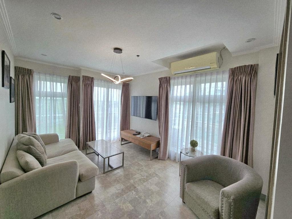 a living room with a couch and two chairs and a table at La Grande Residence 1BR Corner unit Phase 2-710 in Angeles