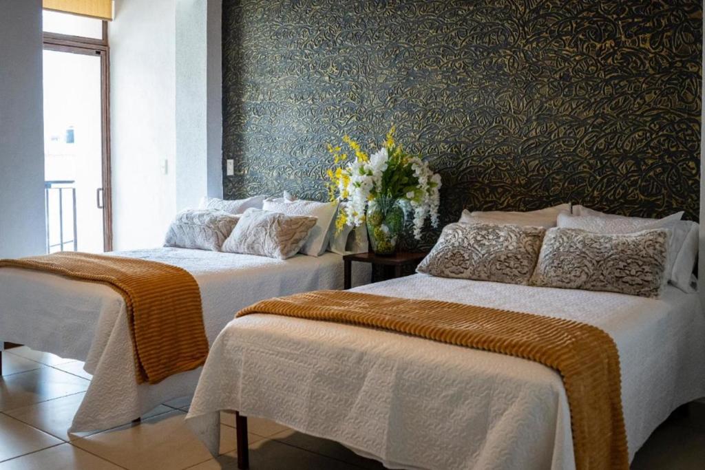 Ένα ή περισσότερα κρεβάτια σε δωμάτιο στο OYO Hotel Casa Zaragoza