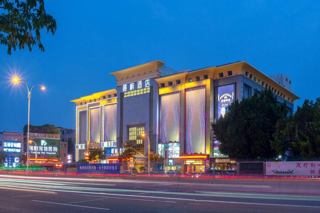 a large building with lights on it at night at Lavande Hotel Guangzhou Panyu Chimelong Xiajiao Metro Station Branch in Guangzhou