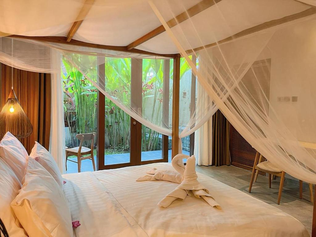 Ένα ή περισσότερα κρεβάτια σε δωμάτιο στο The Moonci Ubud by EPS