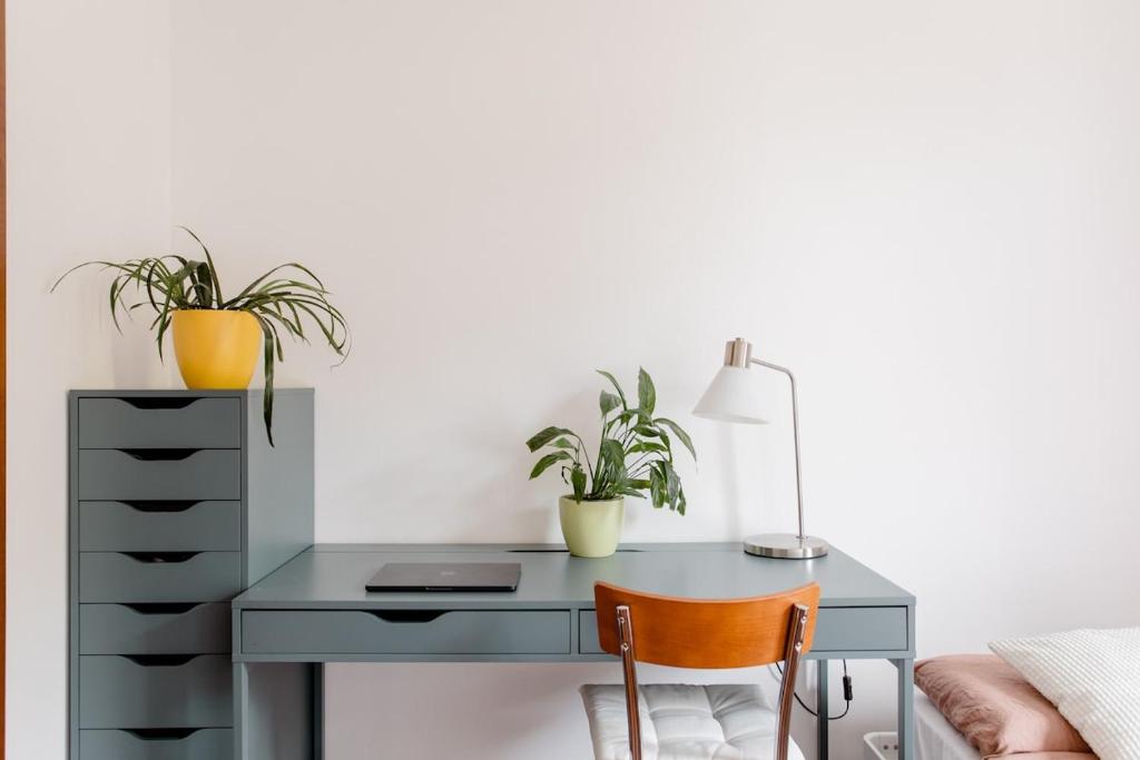 a desk with two potted plants and a lamp at Apartment near Treviso in Silea in Silea