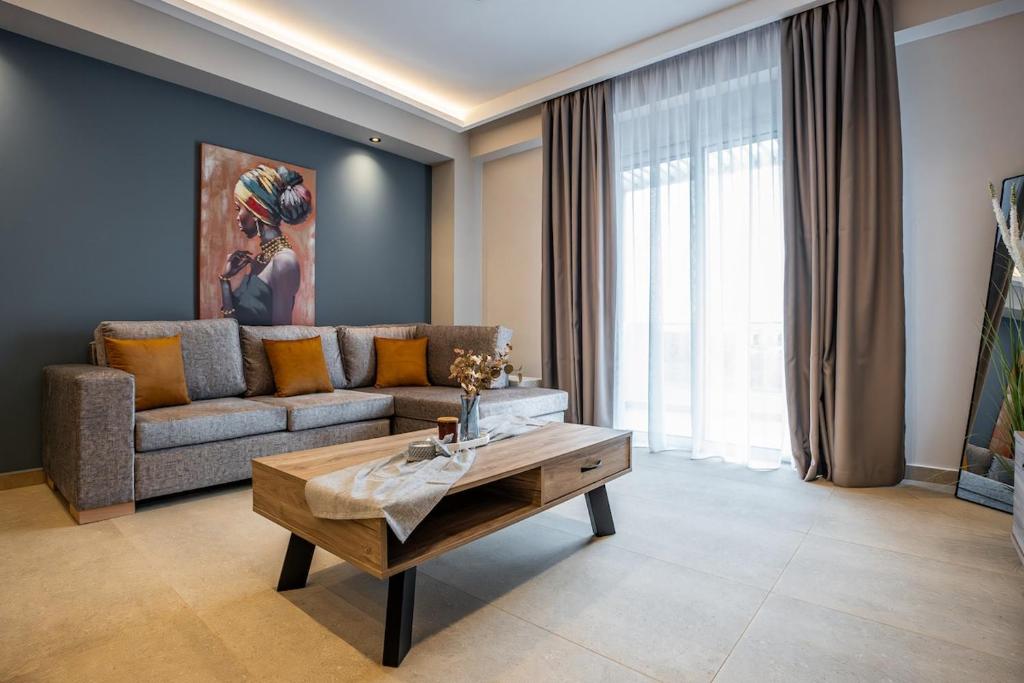 a living room with a couch and a coffee table at Aether, Light Modern Living in Gaïtánion