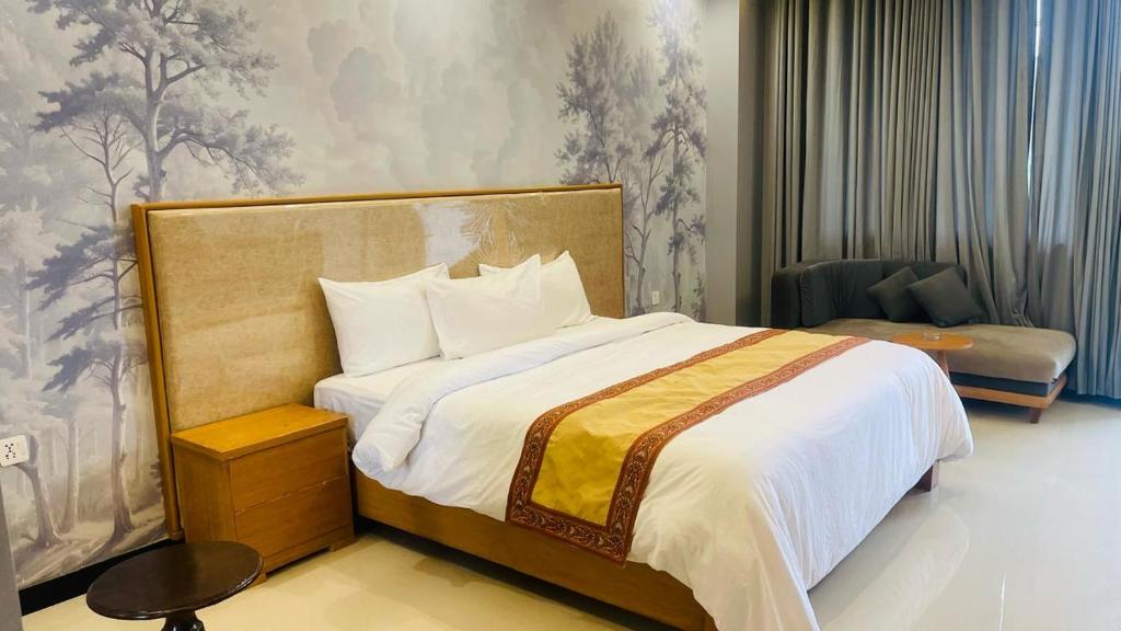 a bedroom with a large bed and a chair at Dreamy Delight in Nathia Gali