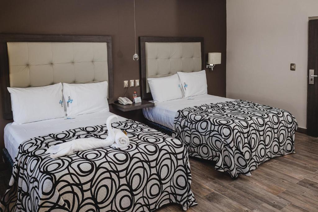 Postel nebo postele na pokoji v ubytování Hotel Flamingo Merida