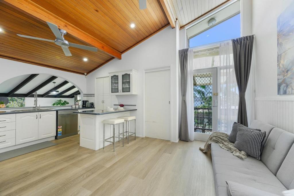 a living room with a couch and a kitchen at Casula cozy 3Br home with parking & WiFi 