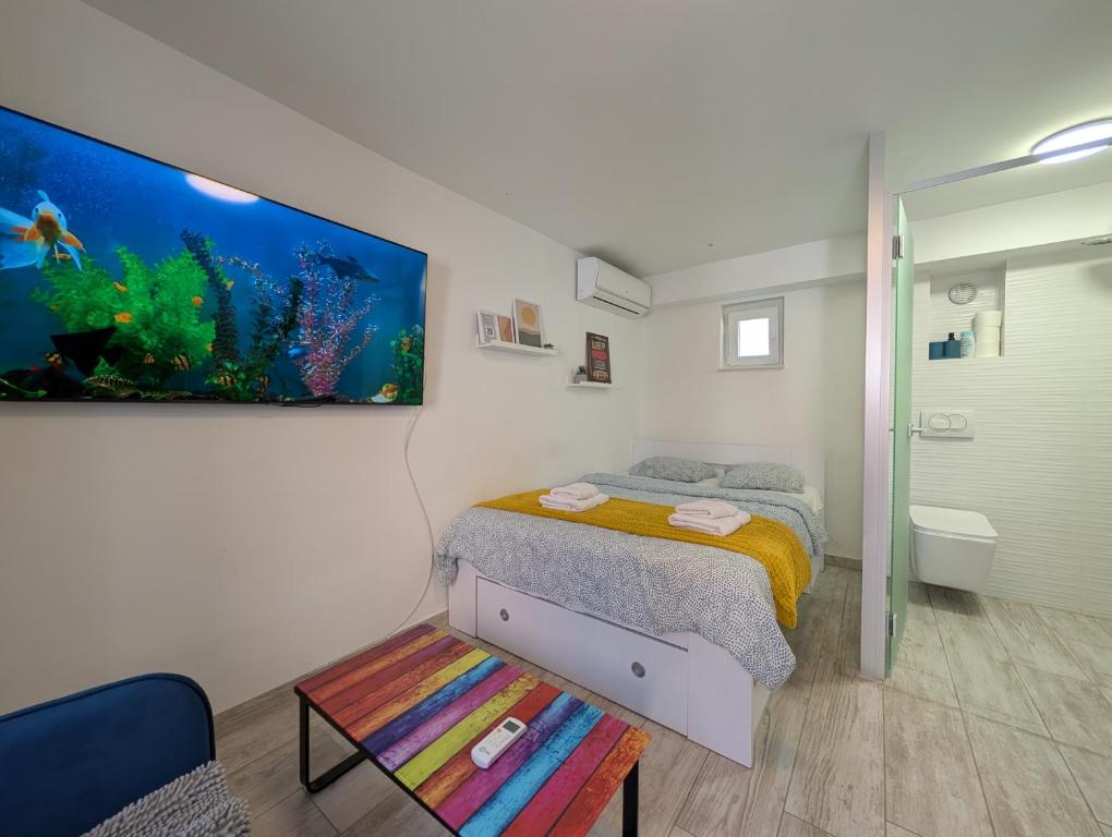 a bedroom with a bed and an aquarium on the wall at Secluded Studio in Central Sesvete in Sesvete