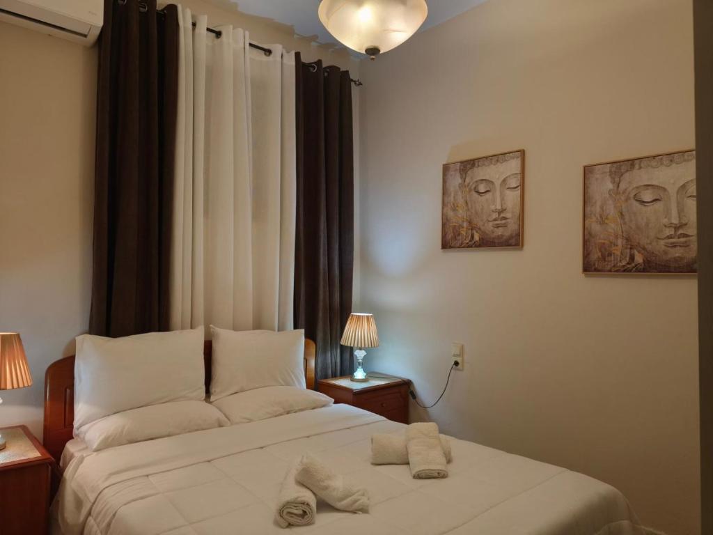 a bedroom with a bed with two towels on it at Maria’s apartment in Amfilochía