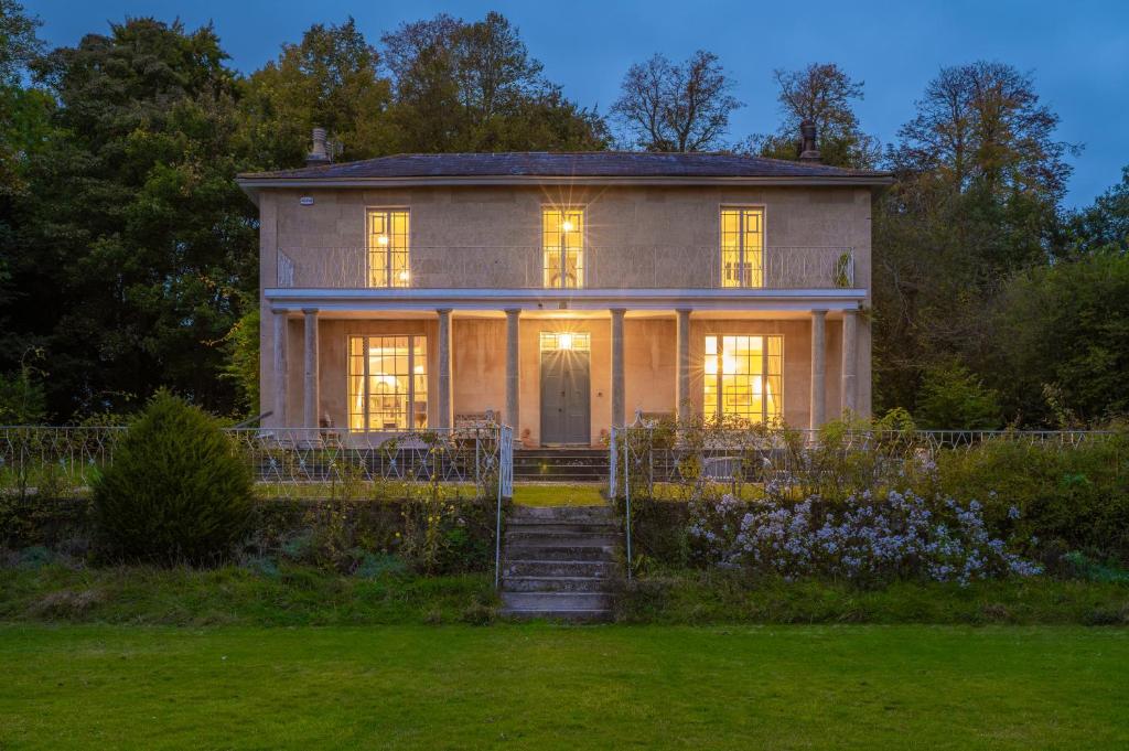 an old house with lights on in the yard at Shrewton House - Stunning 4 double ensuite bedrooms in Shrewton