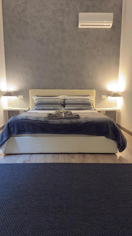 a bedroom with a large bed with two night stands at Residenza Guglielmo - Free Parking in Mantova