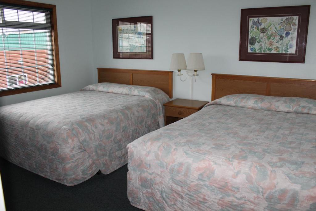 Postel nebo postele na pokoji v ubytování Azalea Lodge