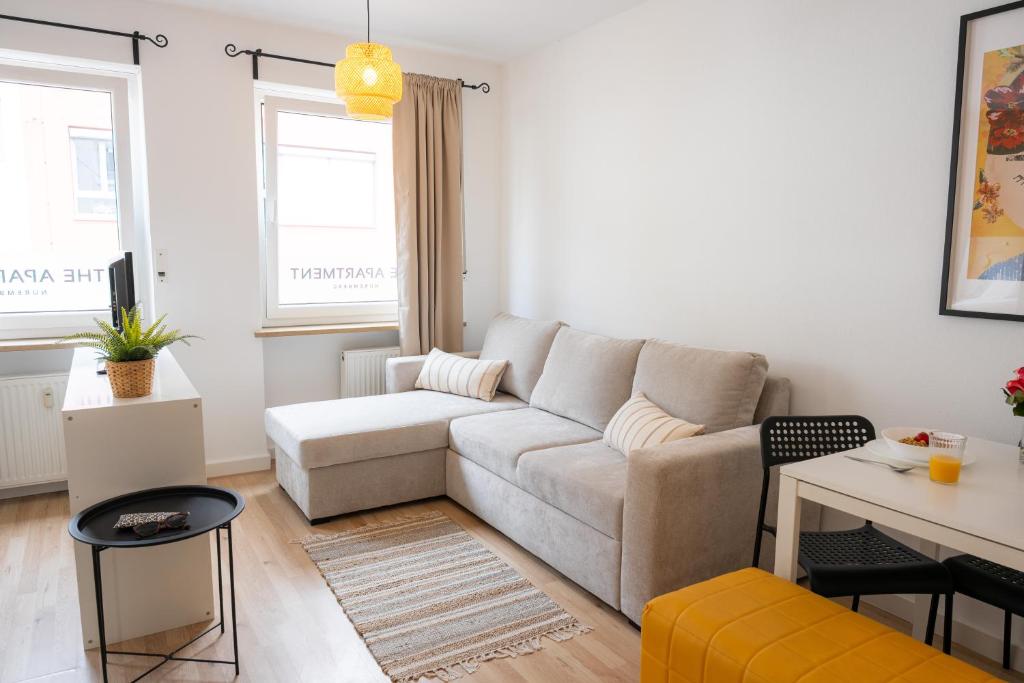 a living room with a couch and a table at Kaisercity Apartment 2 in Nuremberg