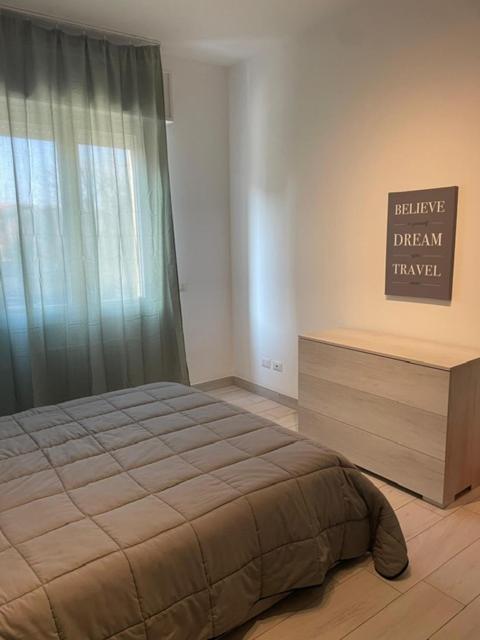 a bedroom with a bed and a sign on the wall at Shining house in Milan in Milan