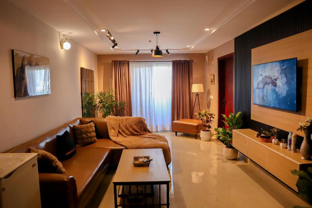 a living room with a couch and a table at Cozy Two-Bedroom Apartment with Balcony in Islamabad