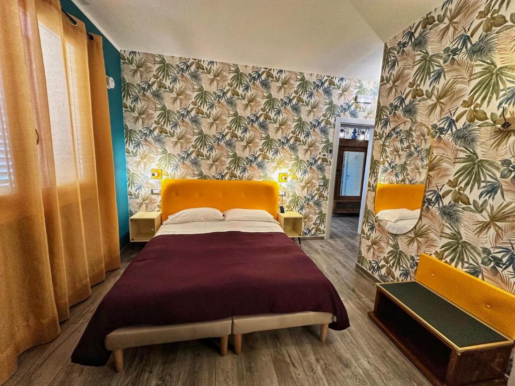 a bedroom with a bed in a room with a wall at AlCivico3 in Civitanova Marche