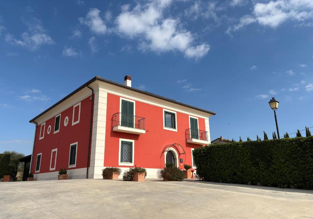 a red and white building with a sky in the background at Agriturismo Villa Luisa in Apice