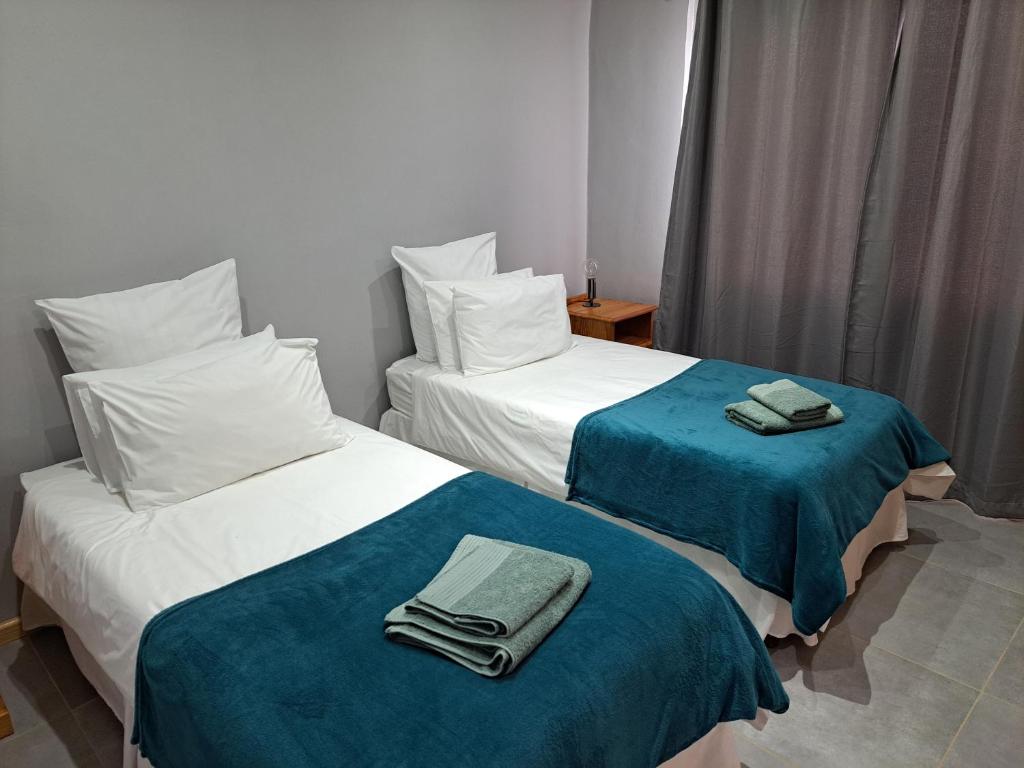 two beds in a hotel room with towels on them at Aqua Farm - Family Unit in Teba