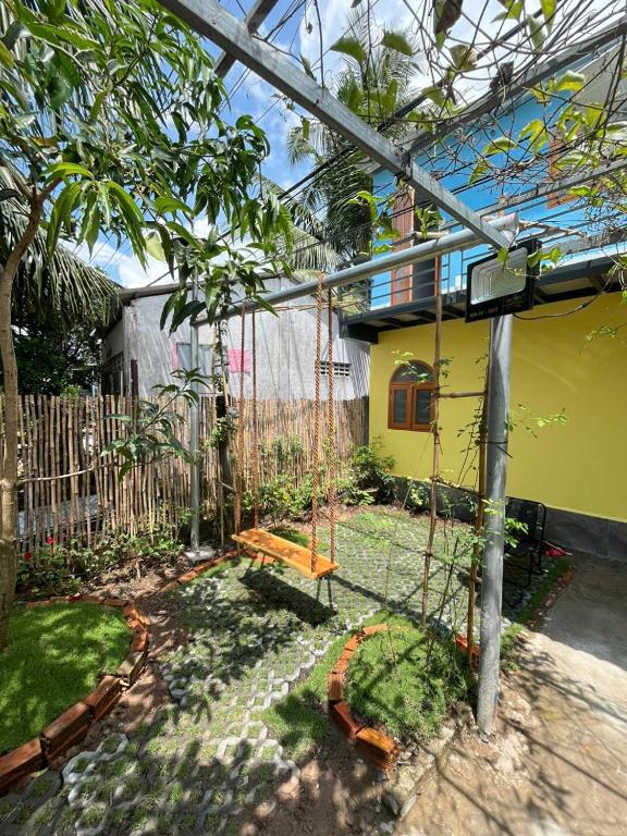 un columpio en el patio de una casa en LUA Homestay, en Vĩnh Long