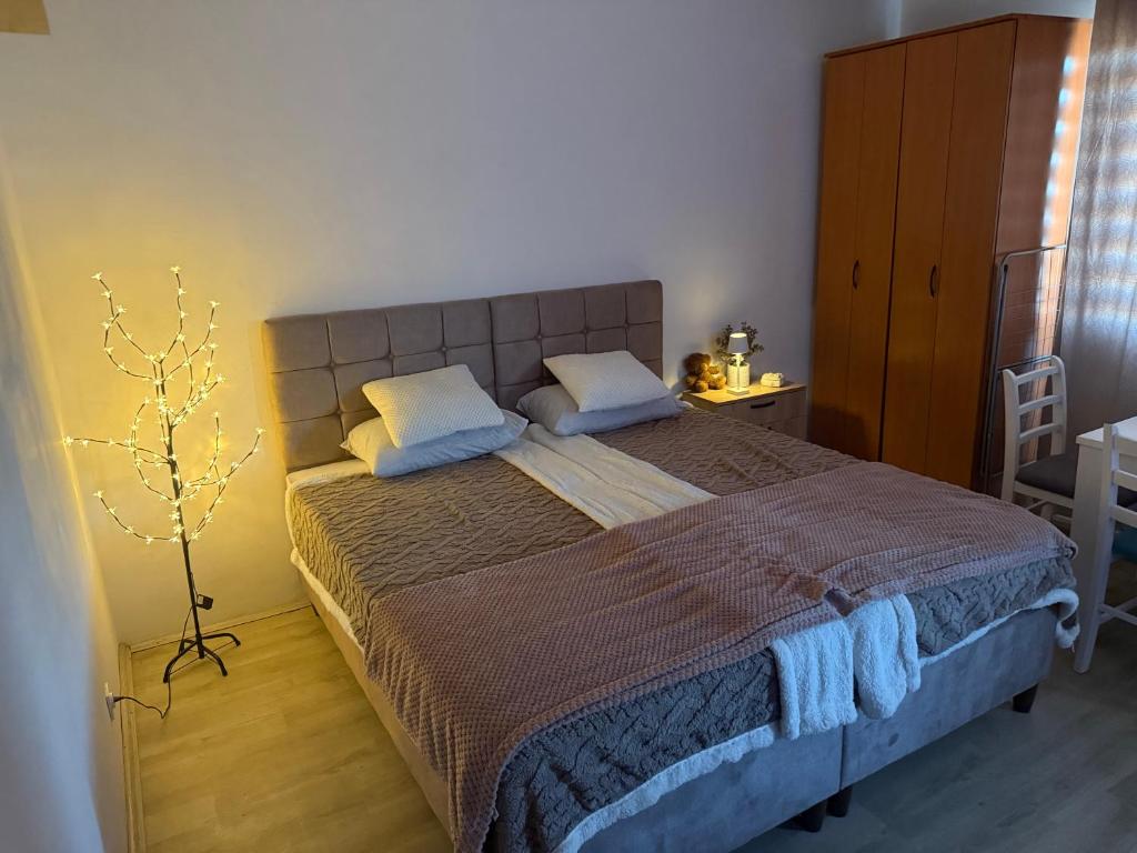 a bedroom with a large bed with blue pillows at Apartman Teodora in Bor