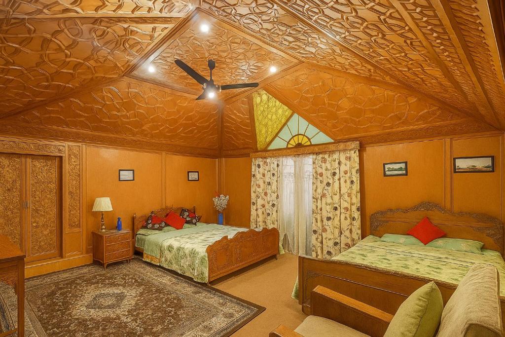 a bedroom with two beds and a ceiling at Shanghai Palace in Srinagar