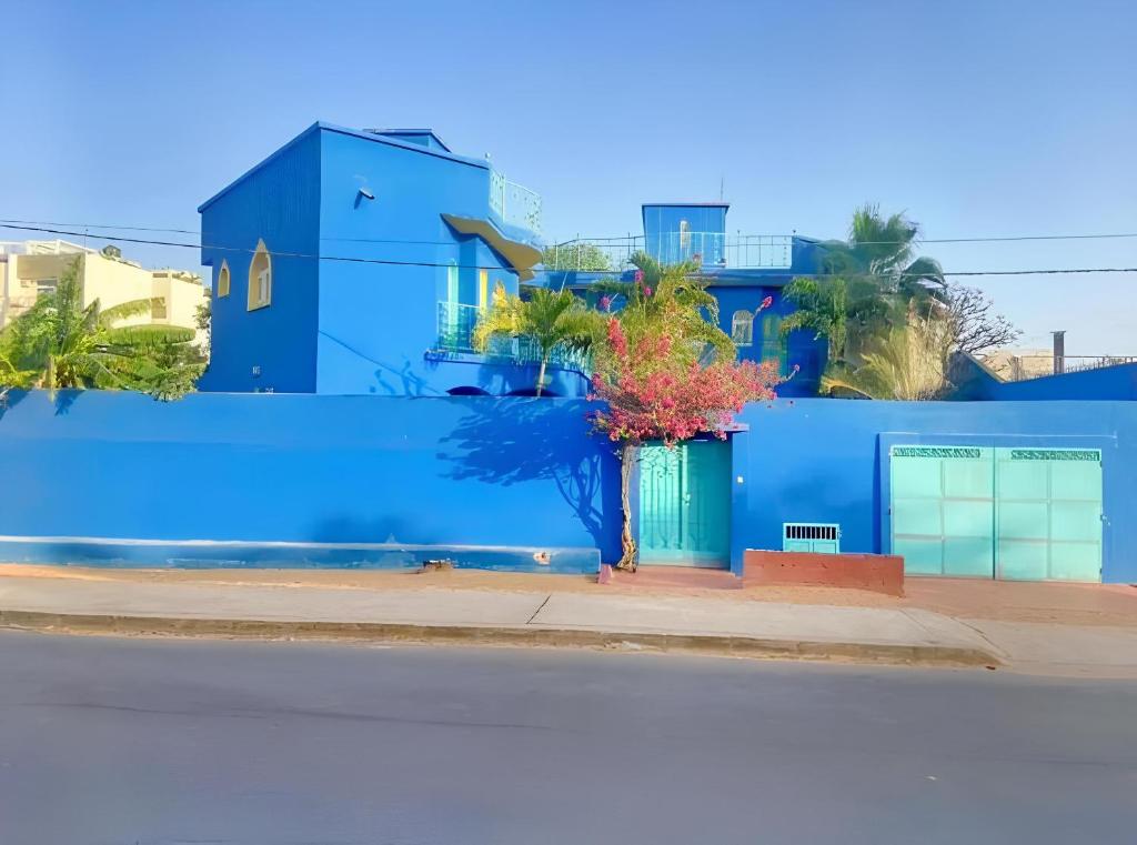 a blue building on the side of a street at Charming duplex - Villa Bleue Majorelle, Saly in Saly Portudal
