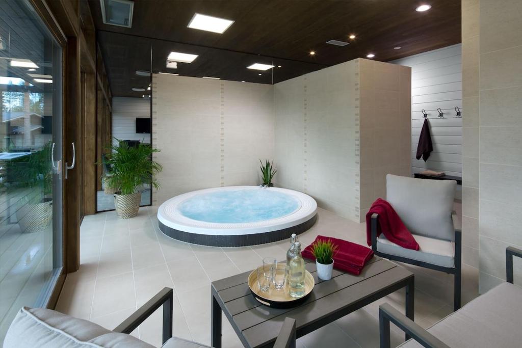 a bathroom with a large tub in a room at Top-equipped Kaarna Spa Villa in Inhantehtaat