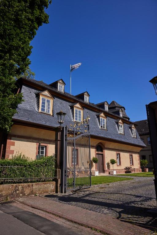 a large house with a gate in front of it at Schloss Hotel Alte Rentkammer in Birstein
