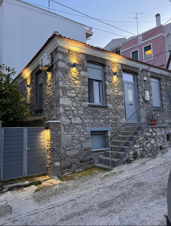 a stone house with lights on the side of it at Sofisstudios in Mytilene