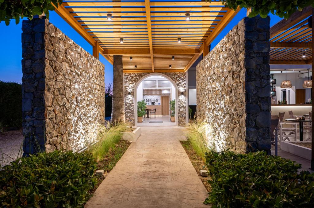 an entrance to a house with a stone wall at Cirillo Family Hotel-Christinas Studios in Mastichari